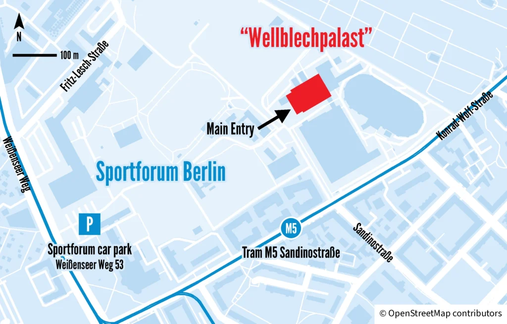 Venue map: the “Wellblechpalast” is in the north-east of the Sportforum Berlin, with the Main Entry at the narrow west end of the hall. Tram M5 stops about 300 metres south at Sandinostraße on Konrad-Wolf-Straße. The Sportforum car park is in the south-west, at Weißenseer Weg 53.